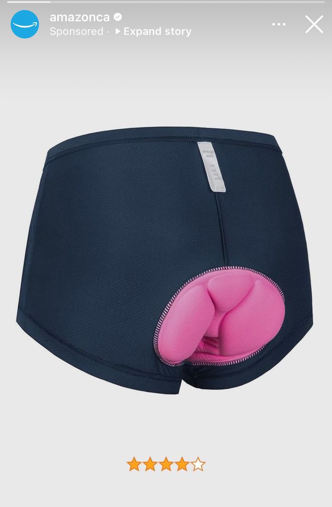 A pair of extremely unfortunately designed bicycle shorts with bright pink seat padding reminiscent of a baboon in estrus