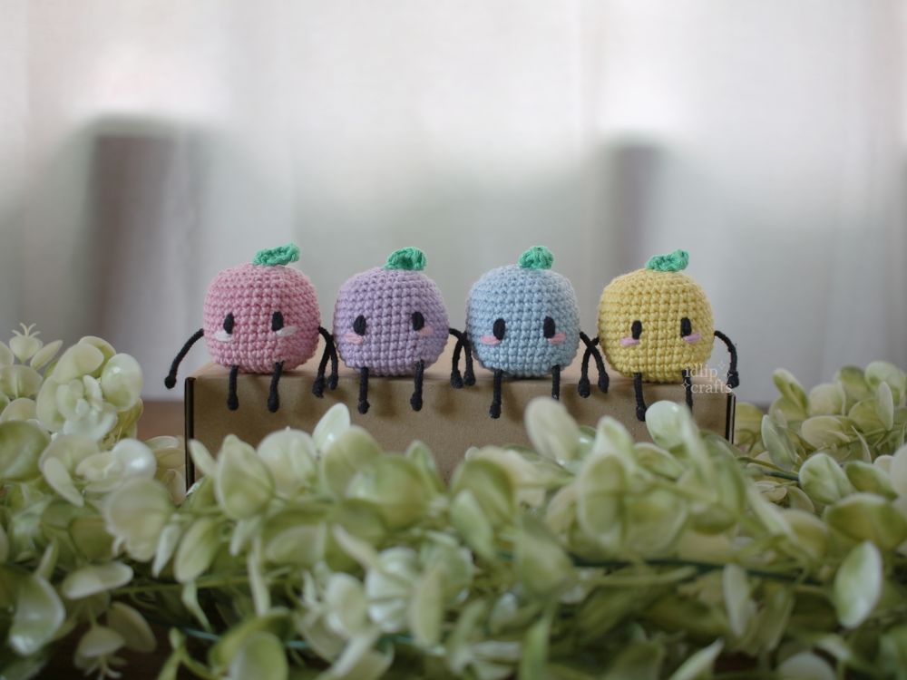 crochet junimos sitting in a row