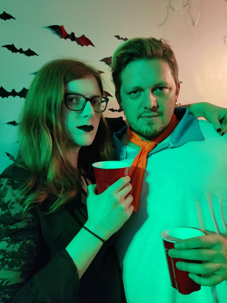 Image of two individuals, me with a goth vampire outfit on, and my friend Daz with a Freddy (Scooby-doo) costume