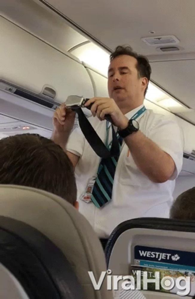 a man in a white shirt and tie is talking to a westjet passenger