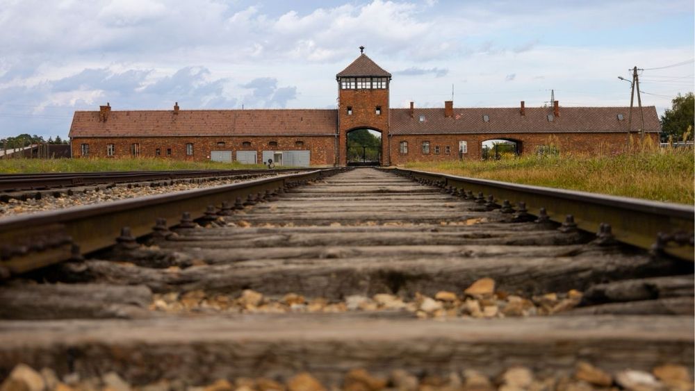 A California governor candidate gets widespread condemnation after posting a photo of himself at Auschwitz with "unemployment plan" caption.