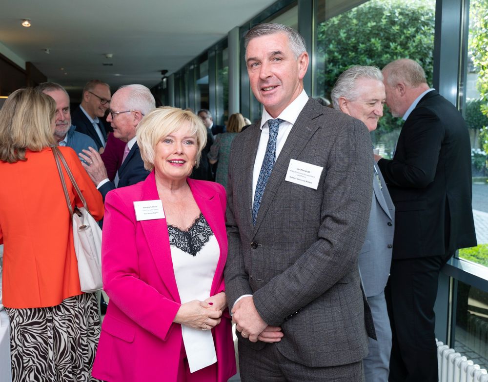 Photograph of Pamela Arthurs (Chief Executive at East Border Region) and Ian Marshall (Head of Business Development and Policy, Centre for Advanced Sustainable Energy, Queen's University Belfast) with delegates in the background.