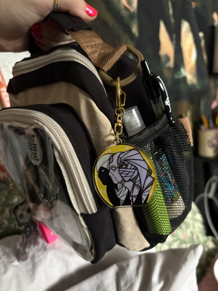 a right side view of my bag, showing a charm and items in the side
pocket