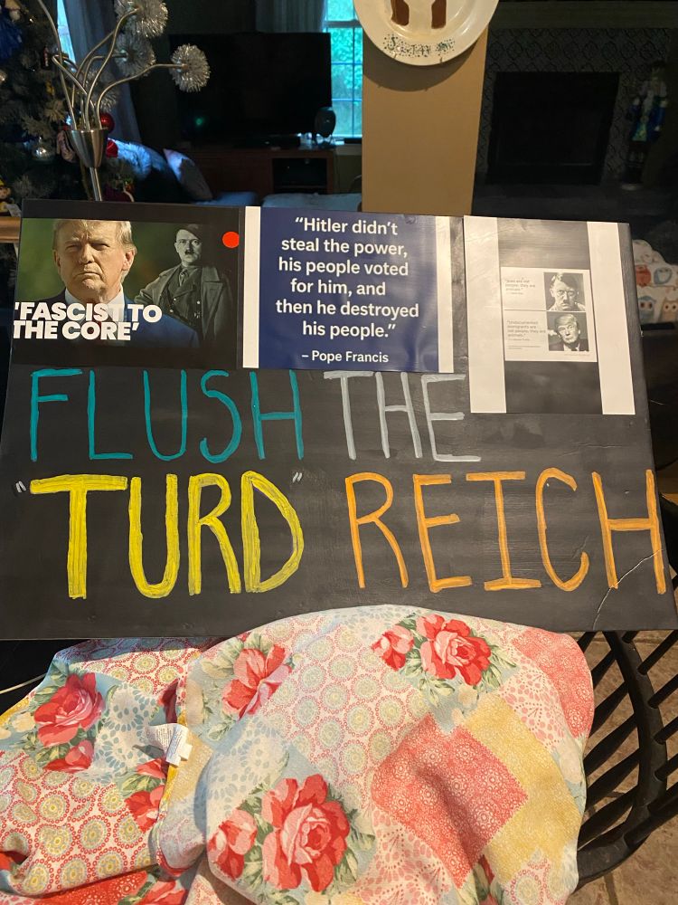 Protest sign that says “ Flush the Turd Reich “