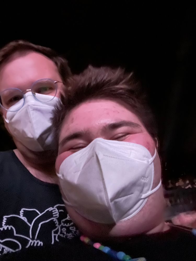 Two masc people wearing masks 