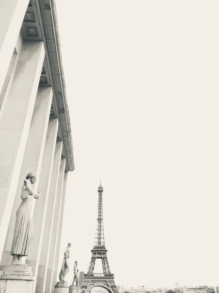 Black and white image of the Eiffel Tower from the Place du Trocadero looking past the Palais de Chaillot. 