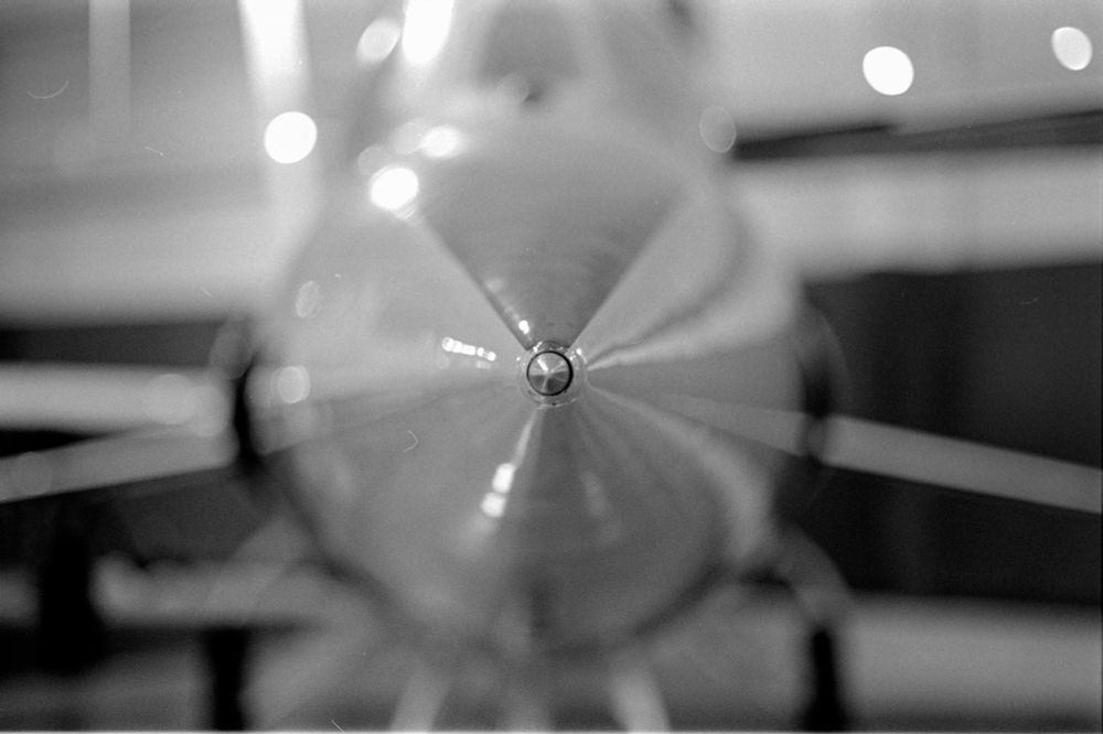 Black & white photo of a Lockheed Starfighter as viewed straight on from the very tip of the nose cone. 