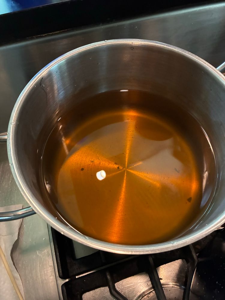 Extracted dye in pot. It is amber-colored.