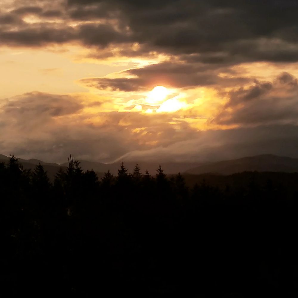 Setting sun lighting up the dark night clouds that are gathering. 