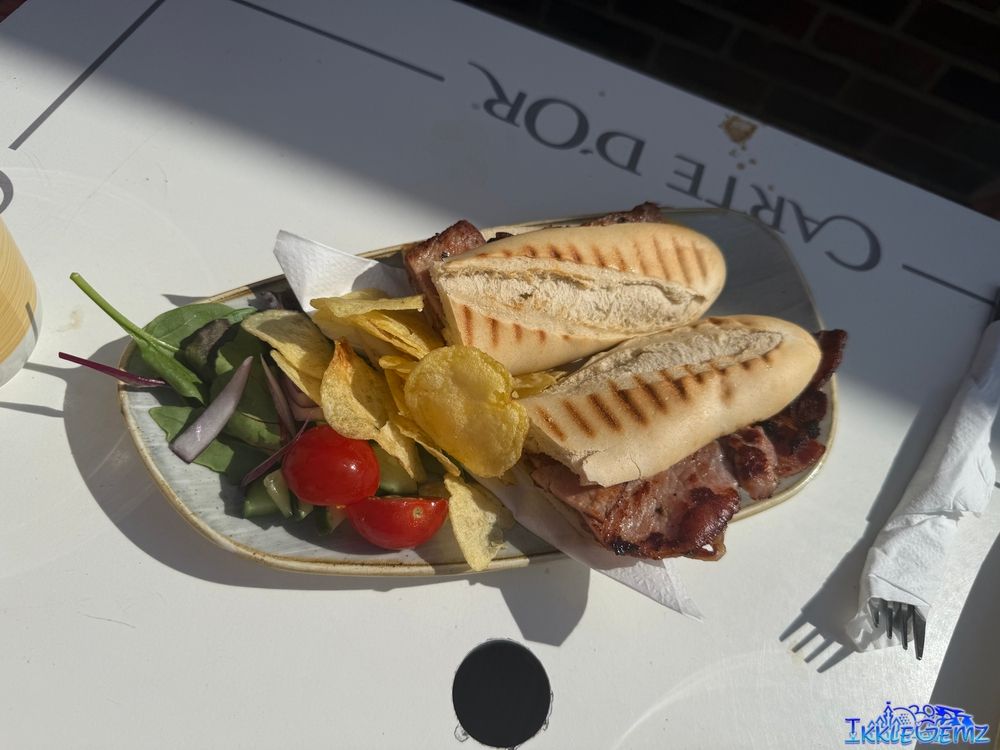 A bacon baguette, garlic bread, coleslaw, balsamic vinegar and salad, greek salad, jacket potato with cheese, salad and coleslaw