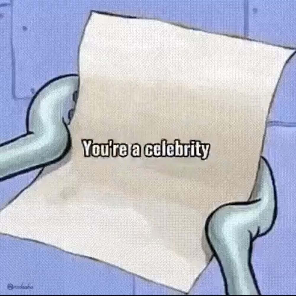 Squidward from SpongeBob holding a note with the words "You're a celebrity" on it.