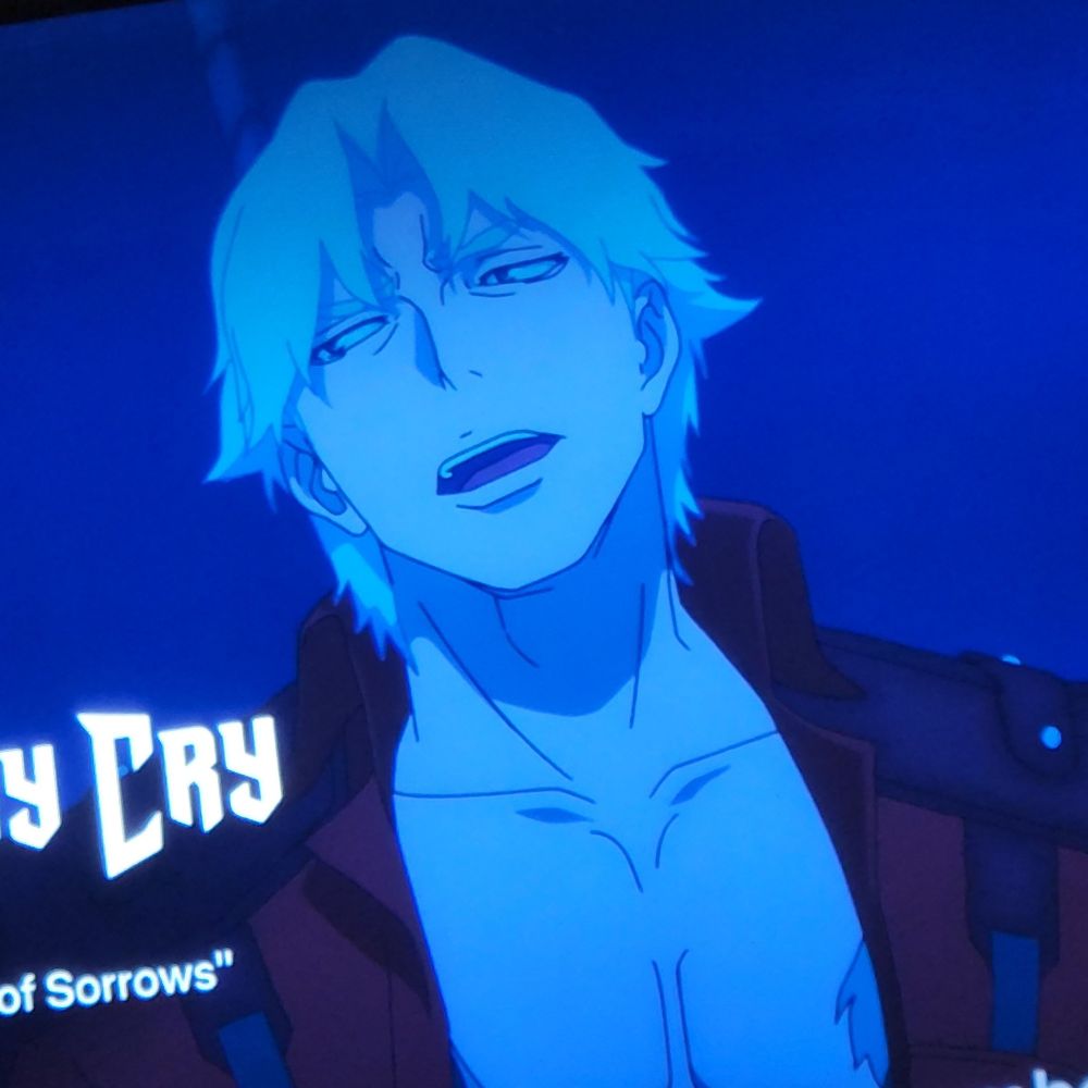 A photo of a TV screen zoomed in on Netflix's Devil May Cry to show a paused still of Dante mid sentence