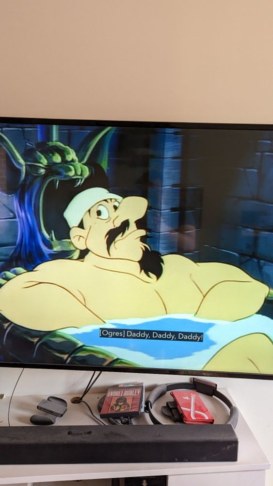Duke Igthorn from Disney's Gummi Bears, a strong man with a black mustache and beard sitting in a bathtub while trolls chant "Daddy, Daddy, Daddy".