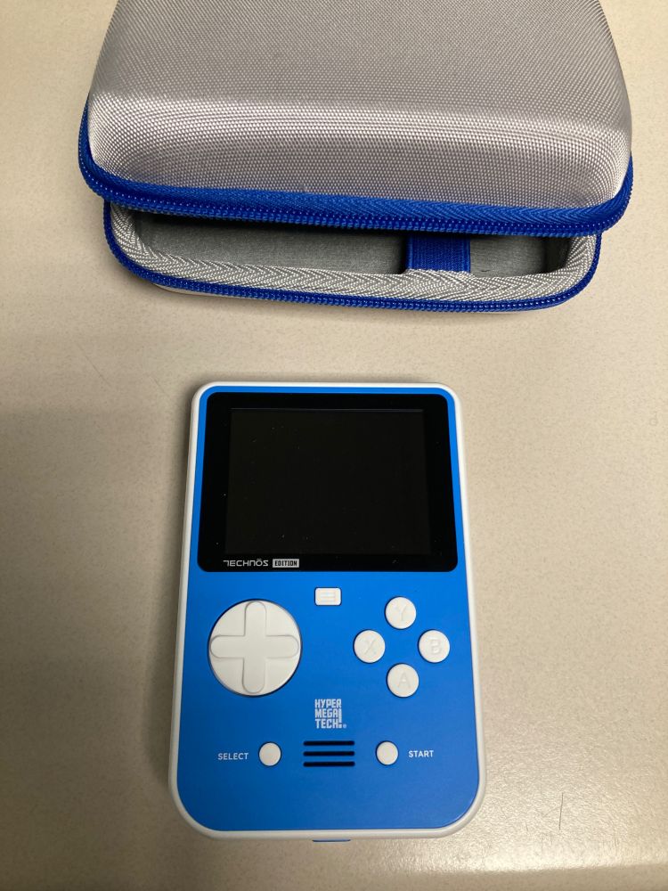 A Super Pocket handheld in blue, along with a grey with blue trim case.