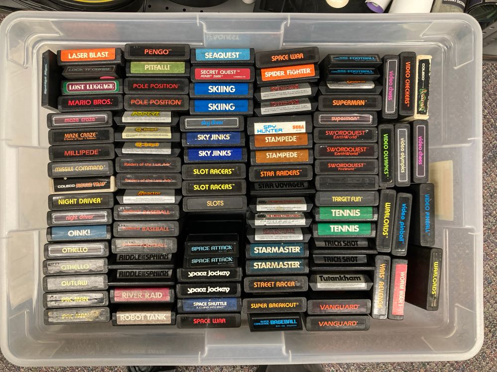 A bunch of Atari 2600 game cartridges in a large plastic bin