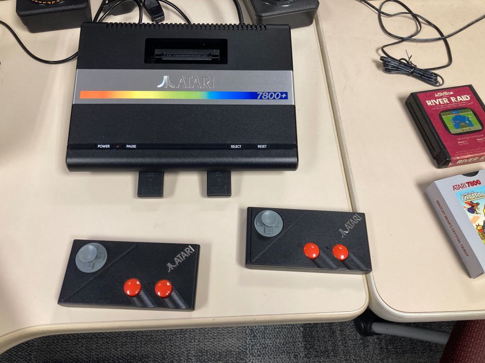 An Atari 7800+ console with two wireless controllers.