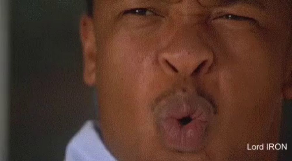 a close up of a man making a funny face with his lips .