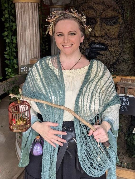 Me at Texas Renaissance Festival wearing a costume  with a crown of antlers. 