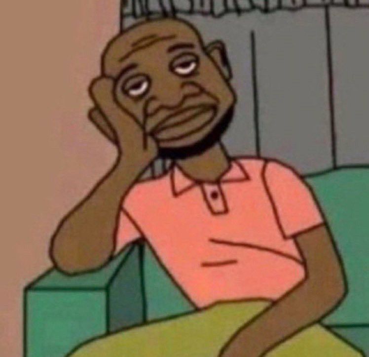 Green couch in front of gray curtains with a pink wall beside it. A Black man with a pink shirt is leaning over exhausted