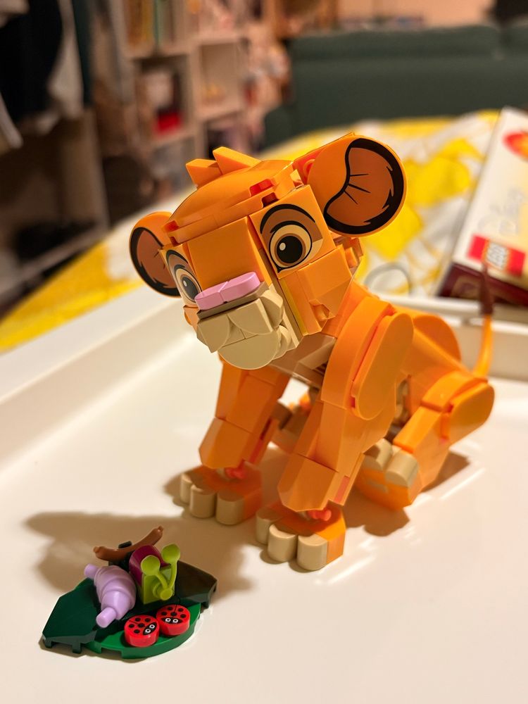 disney simba lego with lego bugs in a sitting position