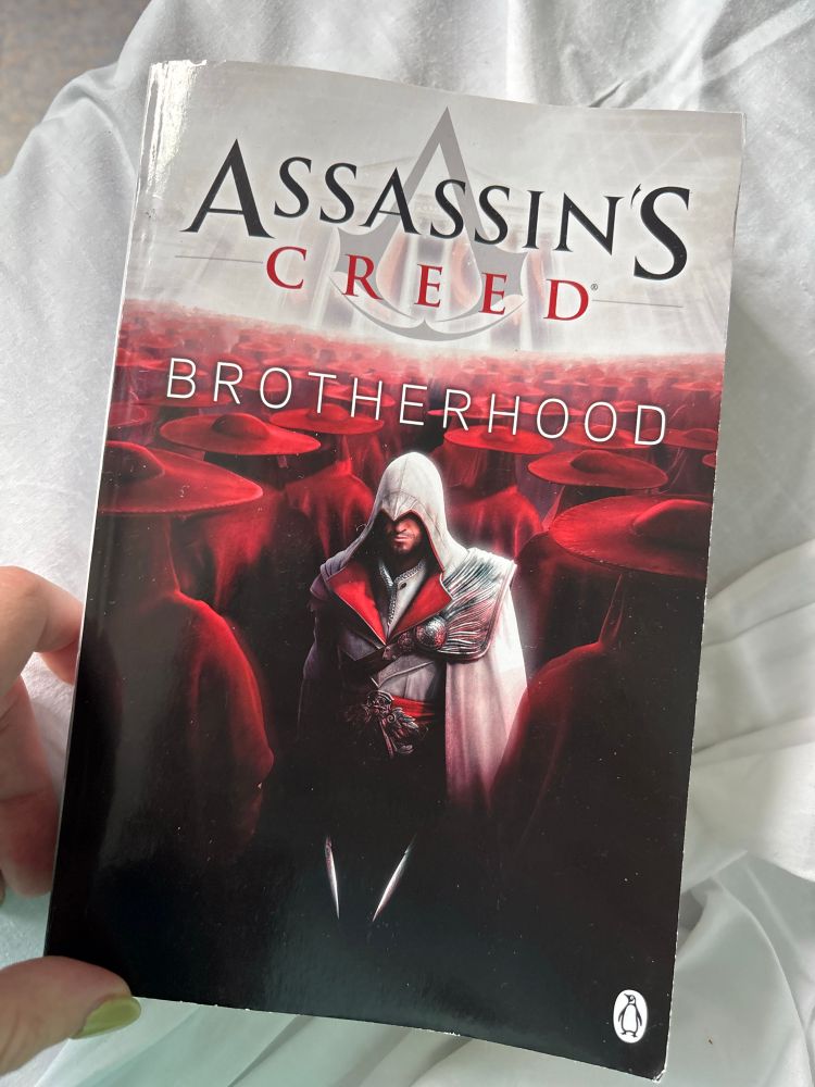 A paperback copy of the Assassins Creed Brotherhood game tie-in novel 
