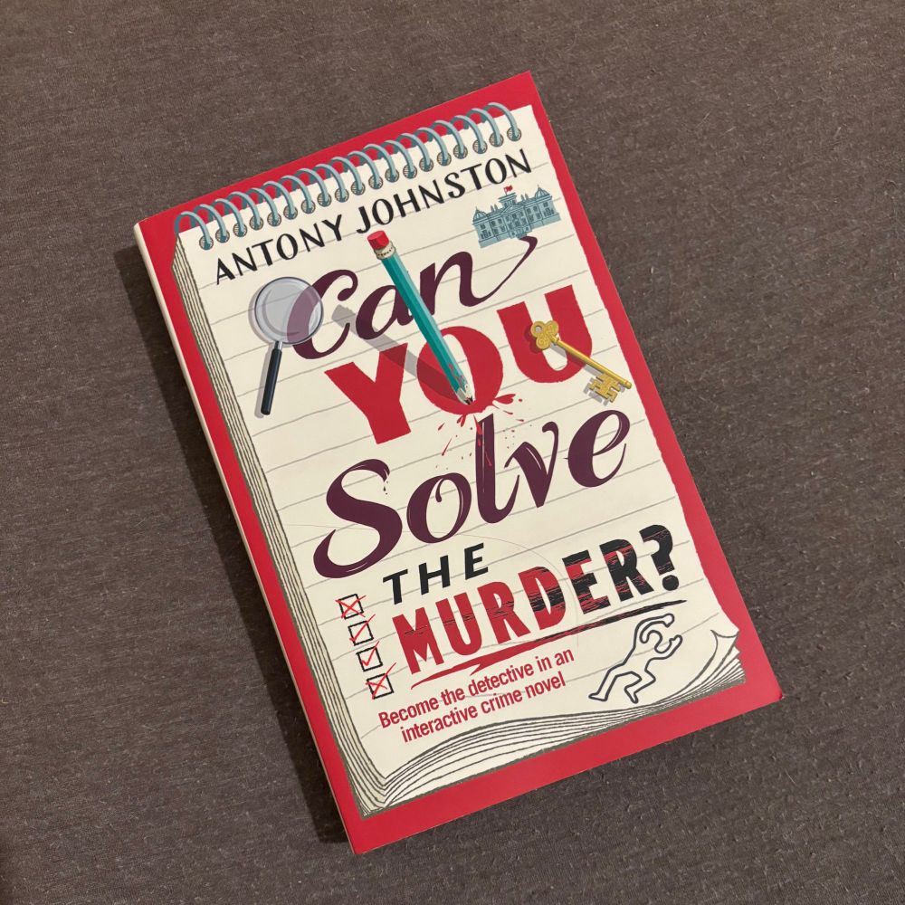 A copy of the paperback proof copy of Can You Solve The Murder, an interactive chose your own adventure murder mystery book 