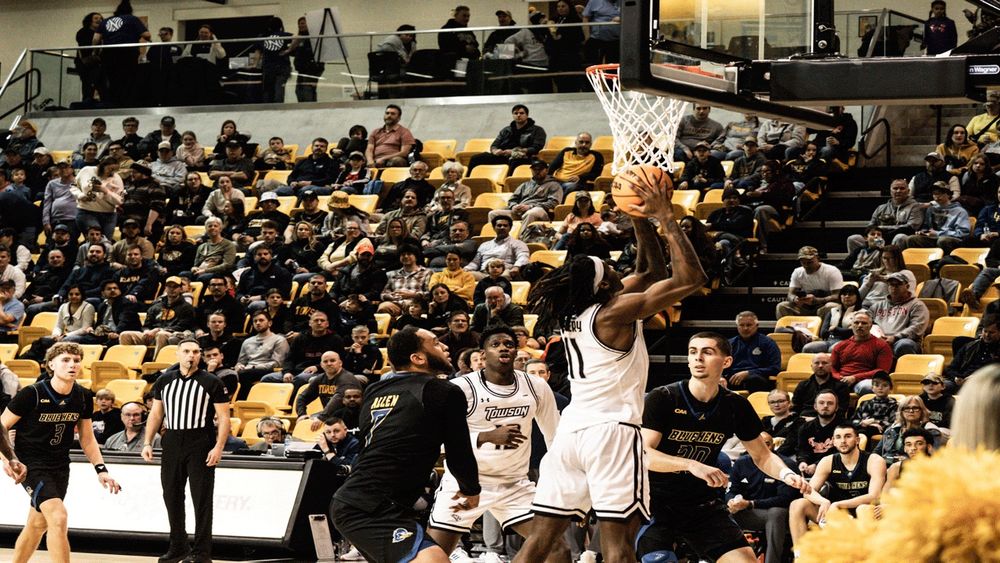 A gif of a Towson University men’s basketball player scoring a dunk. 