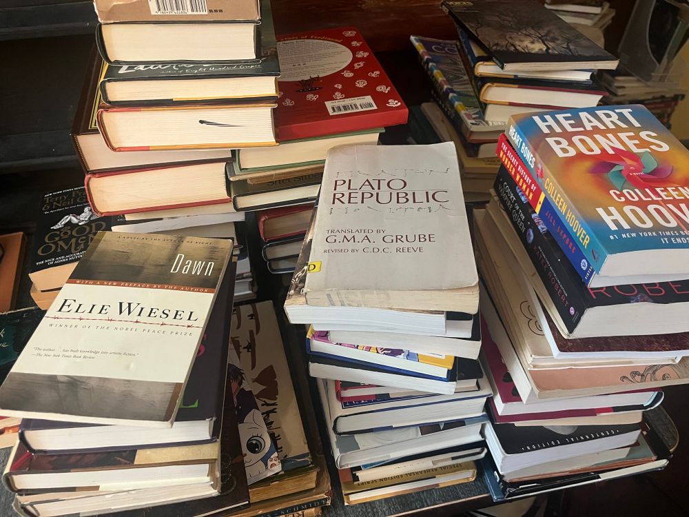 Almost 100 books stacked haphazardly awaiting shipping. :)