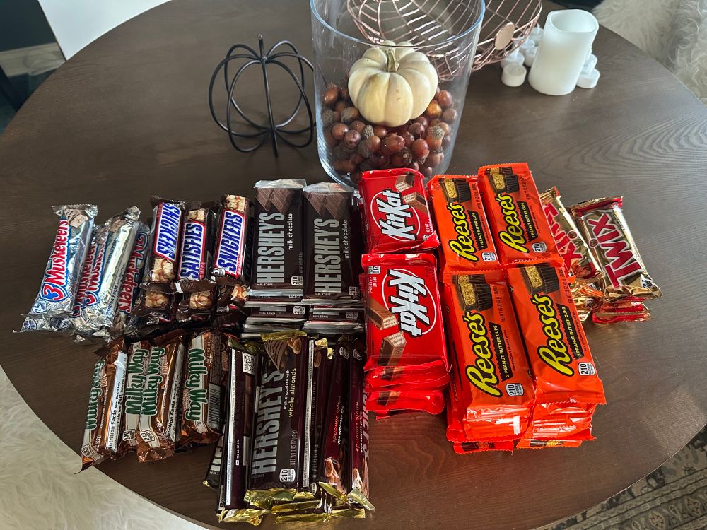 a gaggle of candy bars sits upon a table, waiting patiently for adoption.