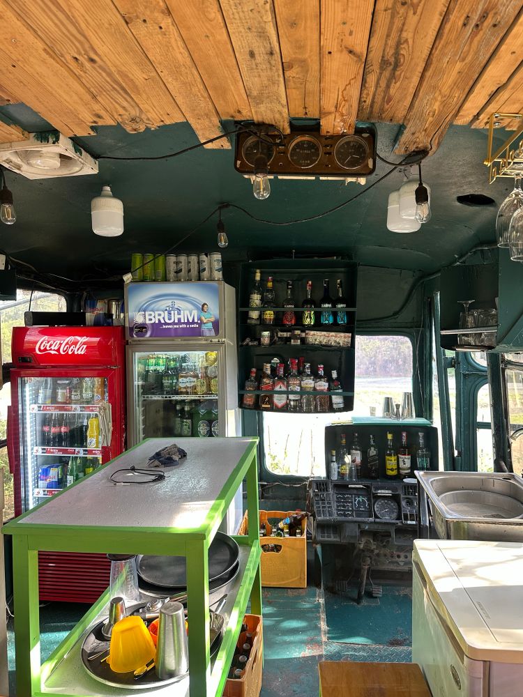Front of a bus modified to a bar nook. 