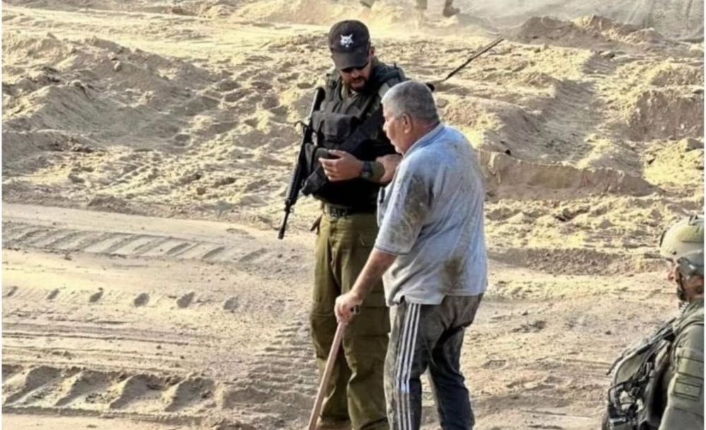 Bashir Hajji's granddaughter says he was shot in the head and back after a photo showing soldiers helping him was taken