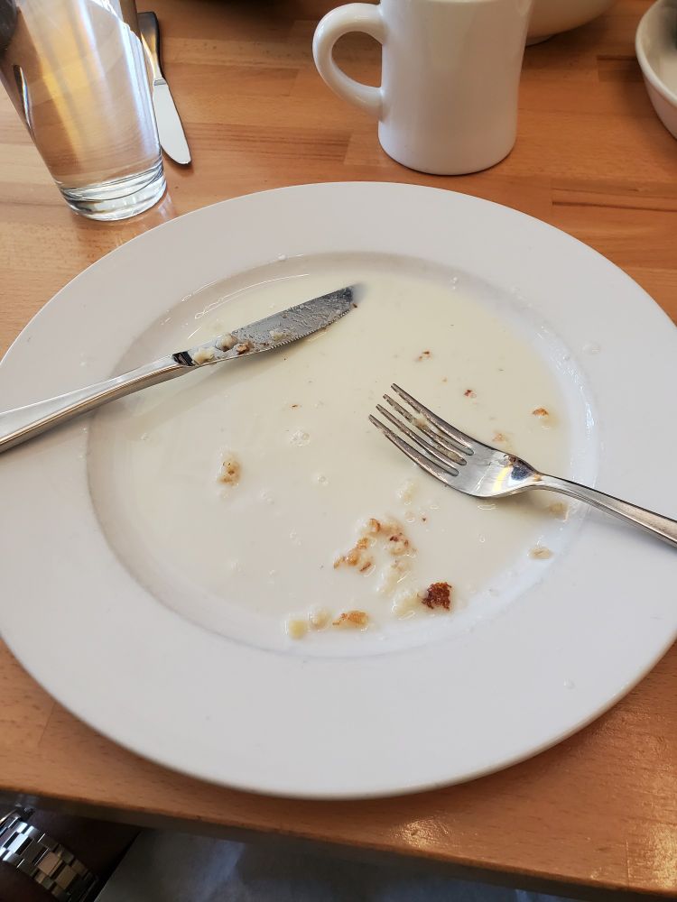 A plate of pancake crumbs swimming in a porcelain pool of sweetened condensed milk, evaporated milk and heavy cream