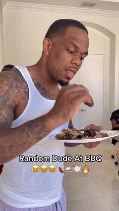 a man in a white tank top is eating a plate of food with the words random dude at bbq below him