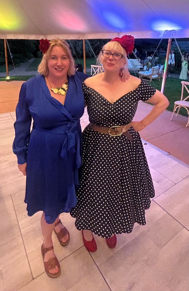 Me and Sycamore Smyth, both in blue dresses and with red headgear on 