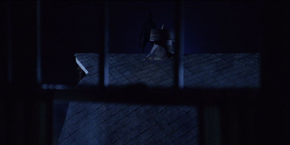 Alien standing on the roof of a barn at night from the movie Signs.