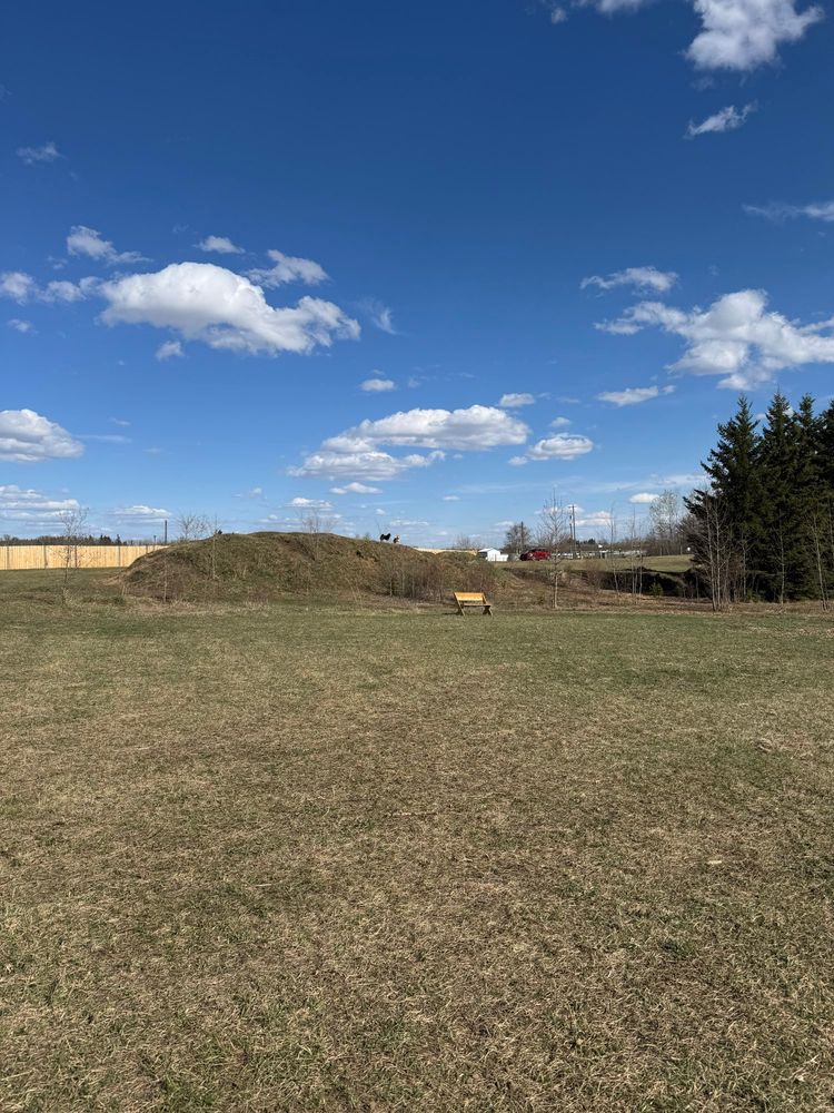 Slightly zoomed picture of the same hill, possibly two figures on the crest 