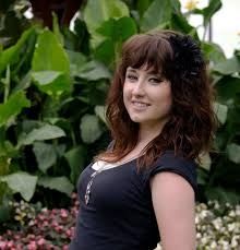 Photo of midge, standing in front of a garden, in 2009