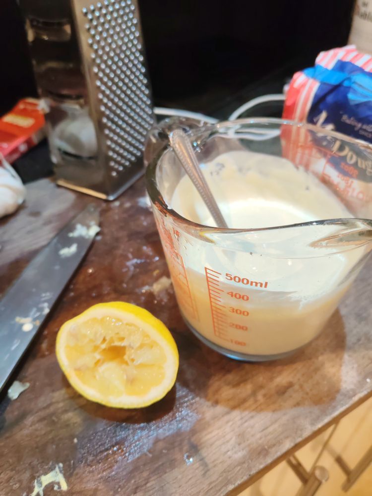 A squeezed lemon half and a jug of cream