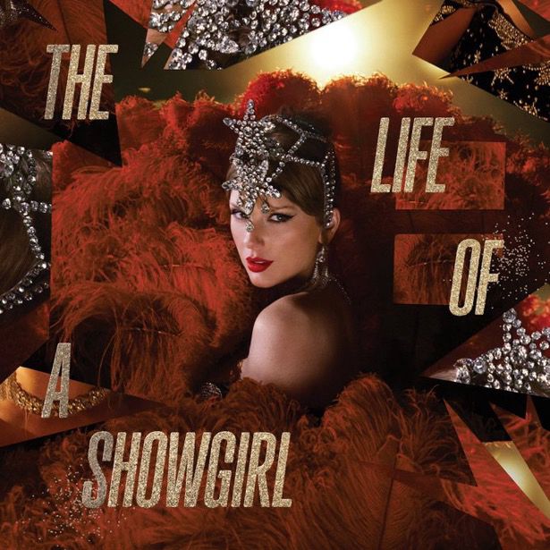 Taylor Swift with red feathers  silver hair price and gold letters that read  “The life of a show girl”