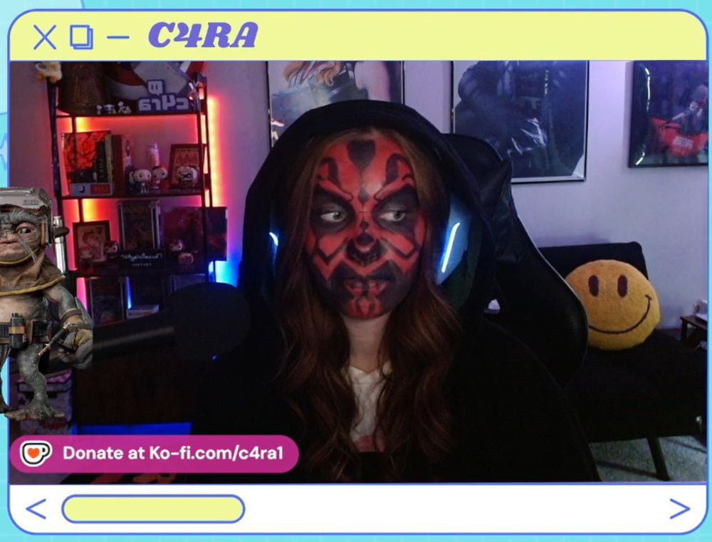 twitch streamer c4ra looking at chat while dressed and face painted as Darth Maul