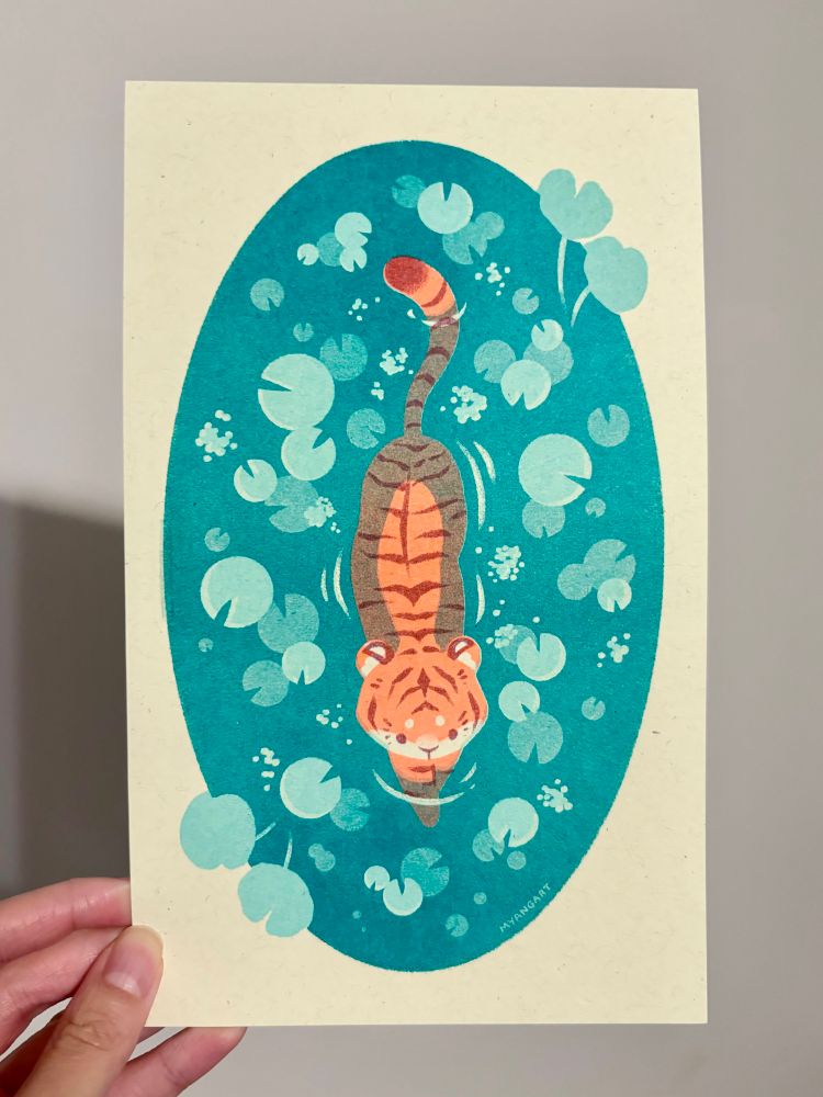 Risograph print of a tiger in a pond surrounded by lily pads. The tiger is fluorescent orange with maroon stripes, and the pond is turquoise.