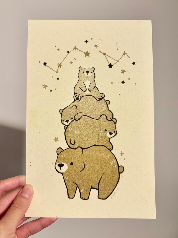 Risograph print of a stack of bears, four tall and getting smaller towards the top. A scatter of stars and constellations lies above them. The print uses flat gold and black ink. 