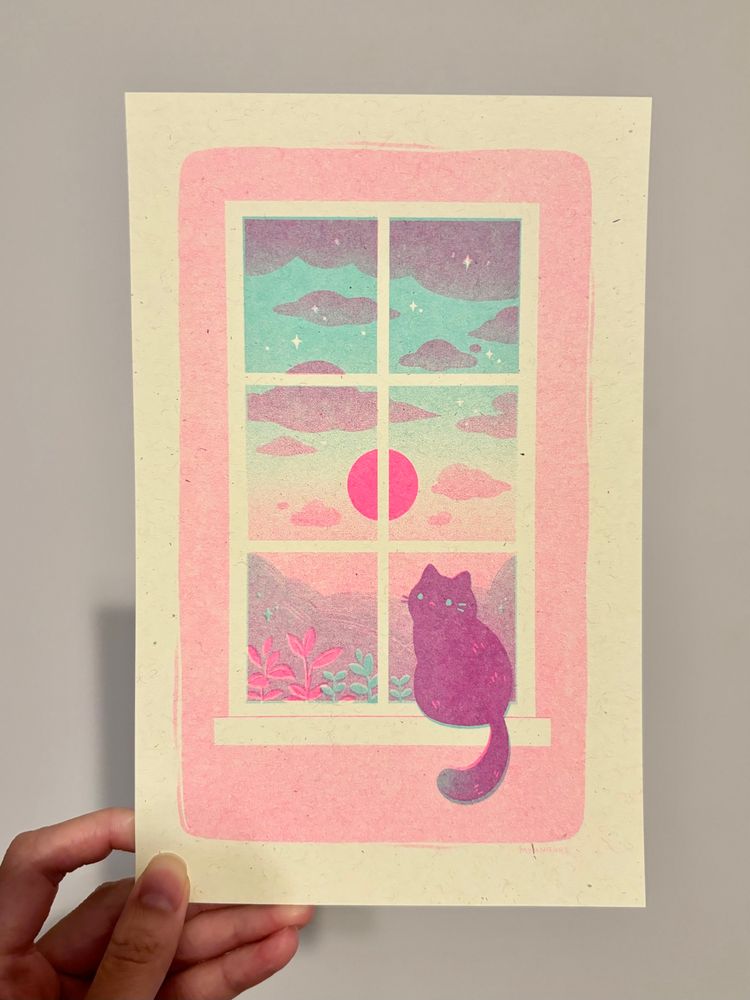 Risograph print of a cat sitting on a window sill while the sun sets outside. The cat is a mix of mint and pink to create a purple tone. Outside there are purple clouds and hills against a sky that gradates from blue to pink. A bright pink sun lies in the middle. 