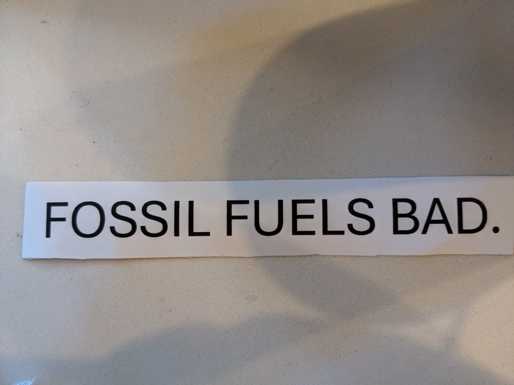 Picture of a piece of paper that says Fossil Fuels Bad.