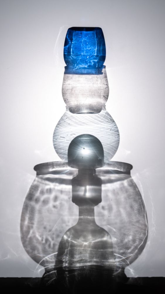 A stack of glass objects balanced in a single precarious tower