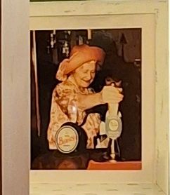 Smiling behatted QM pulls a pint.