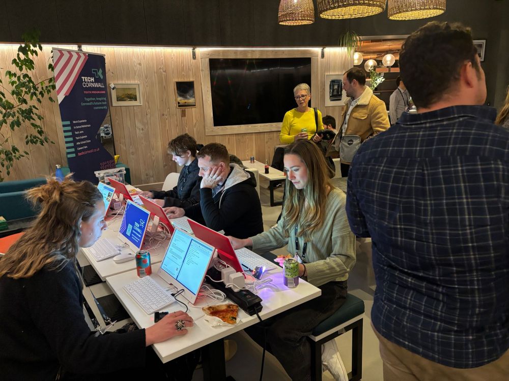 People sitting at computers in a cafe