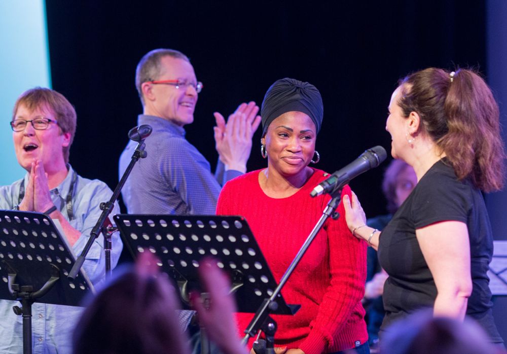 A group of people on stage being congratulated for an amazing performance