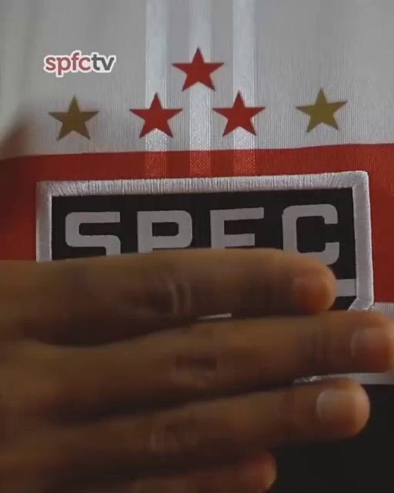 a person 's hand is holding a patch that says spec