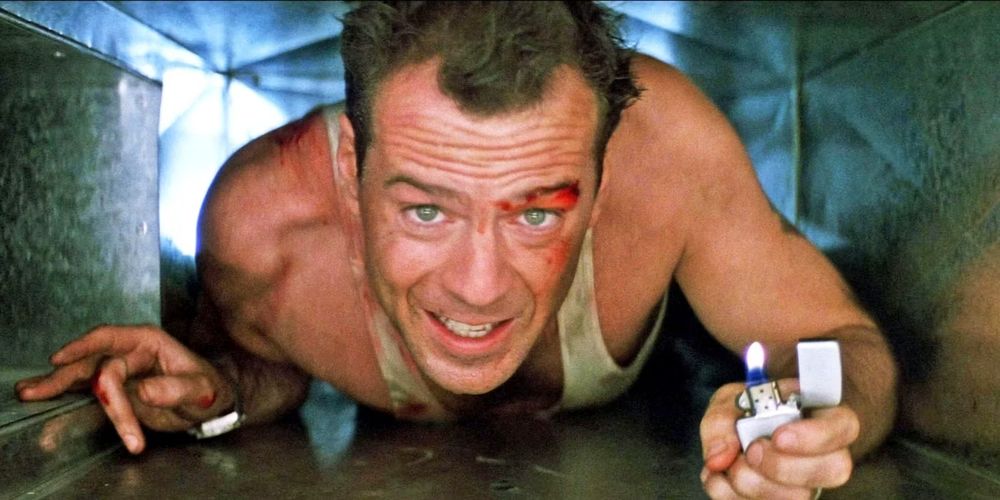 The scene from Die Hard where John McClane (Bruce Willis) is crawling through an air duct holding a lit cigarette lighter, talking sarcastically about coming out to the coast to have a few laughs.